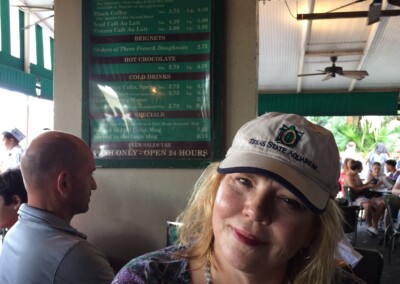 Virginia at cafe du monde with hat