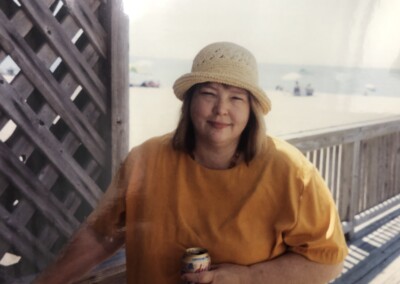 Virginia in orange shirt at beach 2005